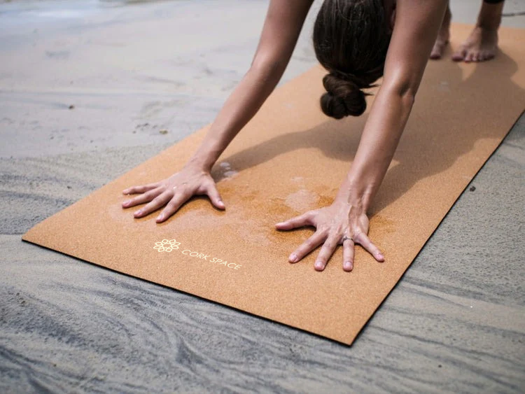 Hands grounded on a cork yoga mat