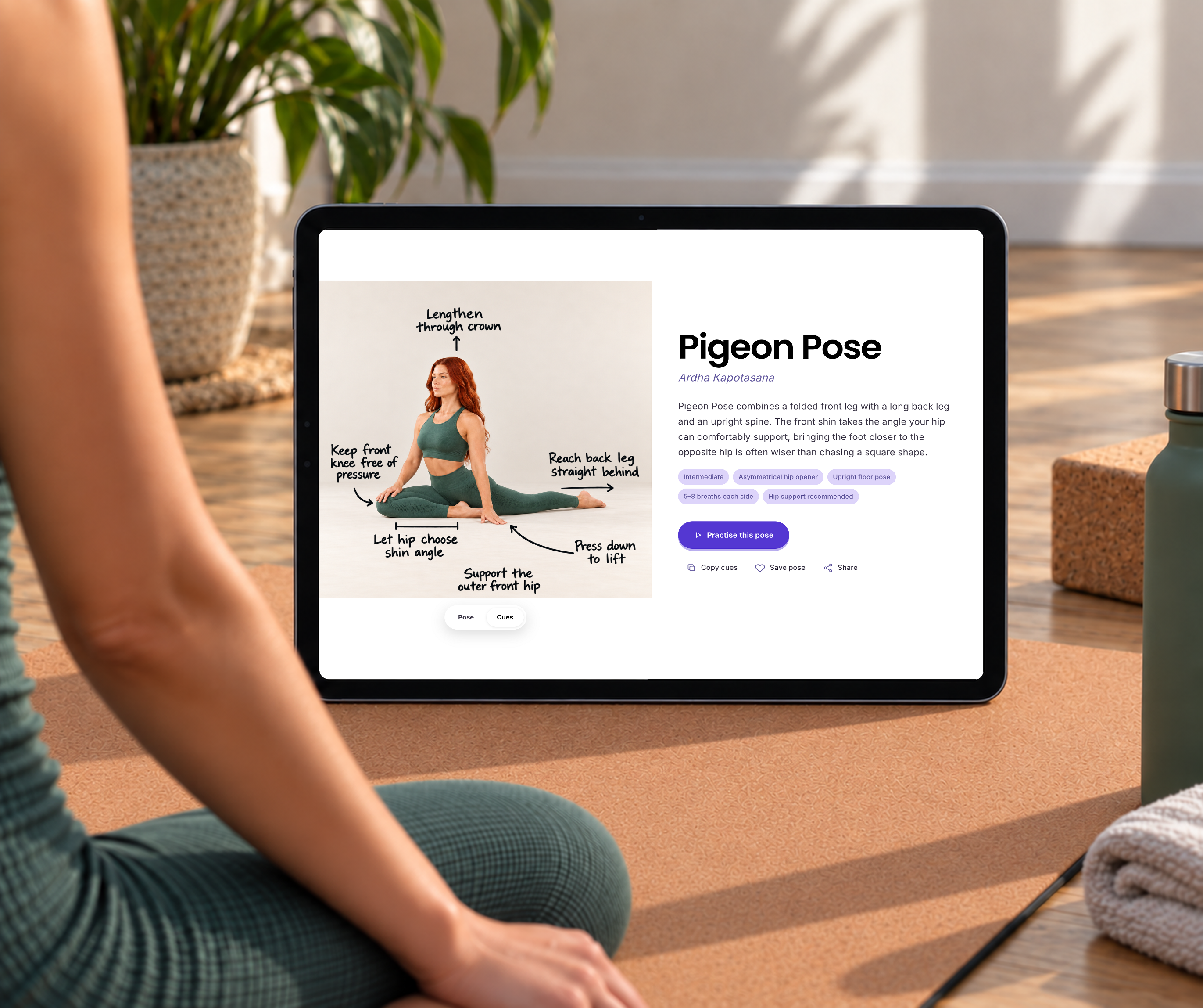 Yoga Space Pigeon Pose with alignment cues shown on an iPad during a yoga practice